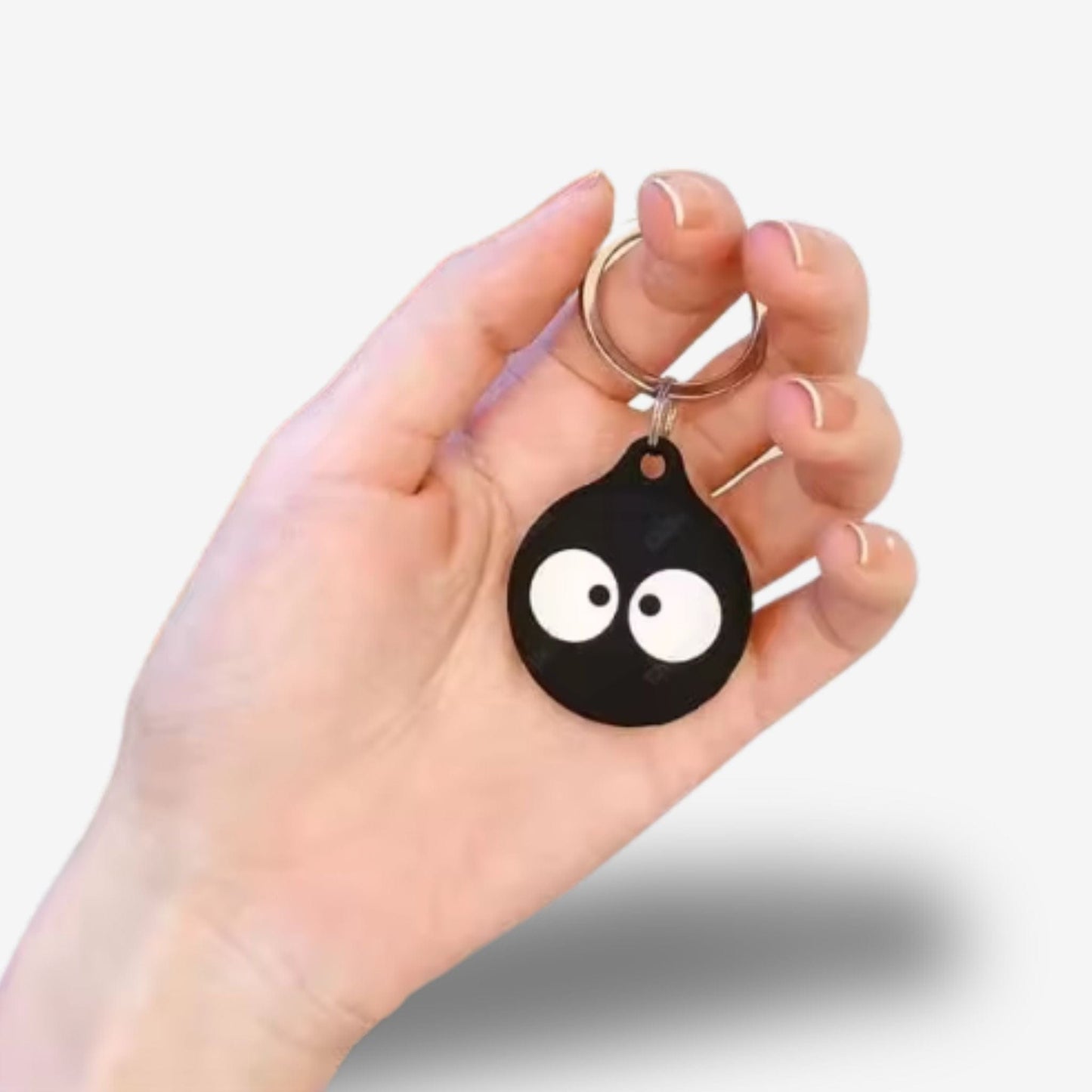 Traceur GPS Enfant <br> Porte-Clés Yeux Qui Louchent sur Fond Noir, Silicone Souple