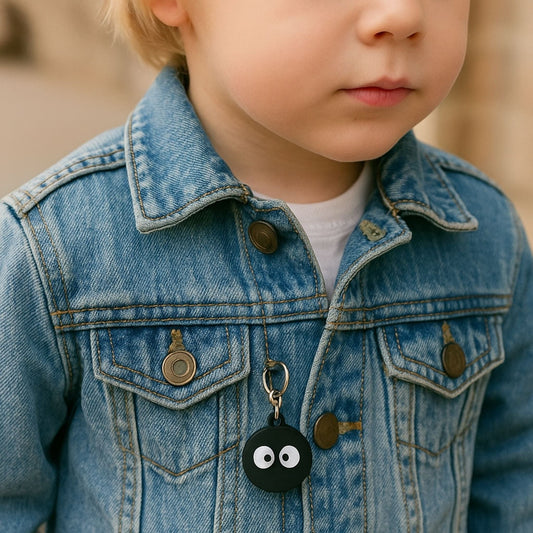 Traceur GPS Enfant <br> Porte-Clés Yeux Qui Louchent sur Fond Noir, Silicone Souple